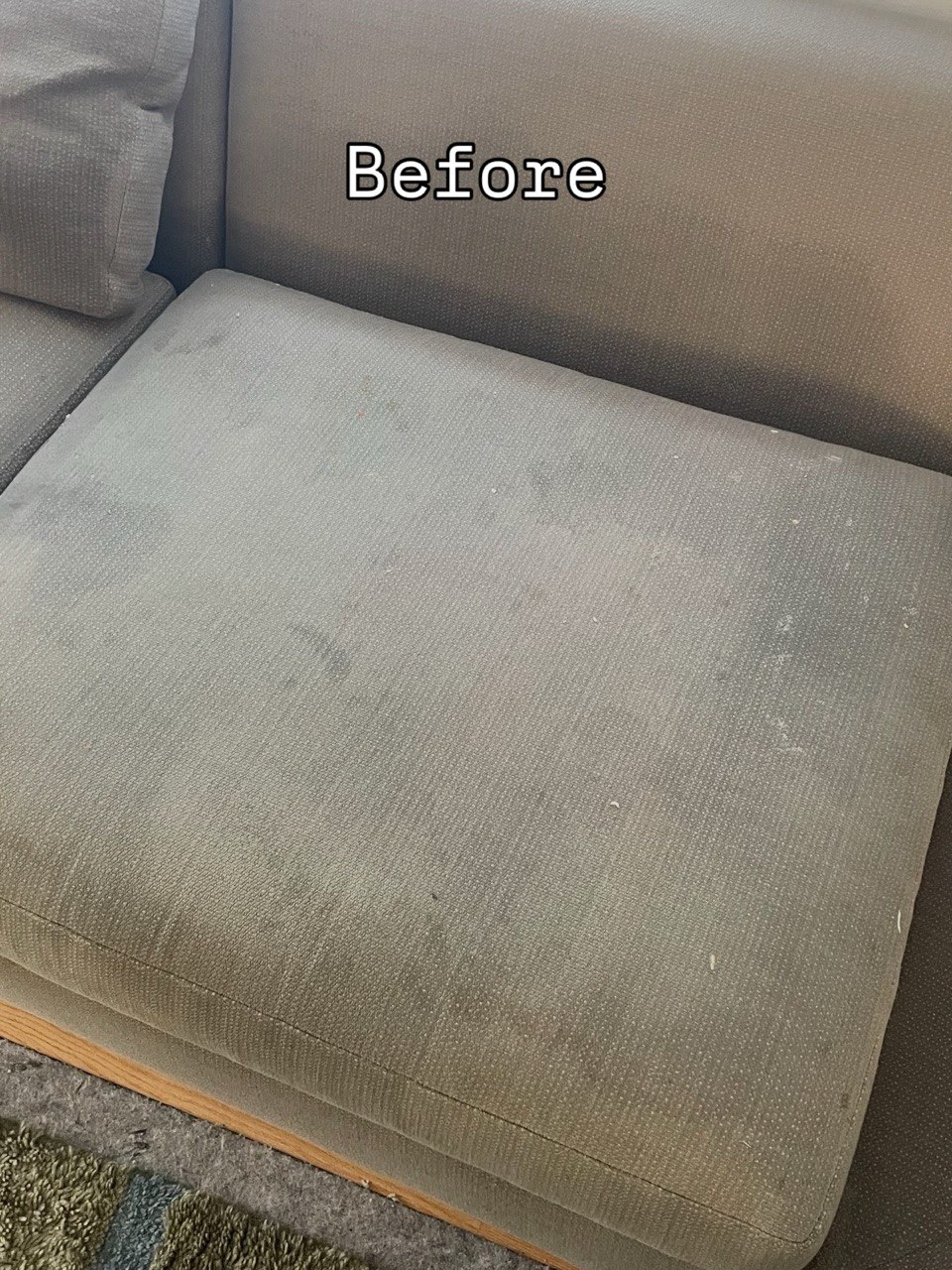 Sofa cushion before cleaning, with dark stains